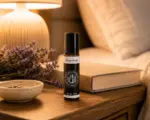Book, low lamp, tea, and a Nature’s Potions aromatherapy roller in an evening setting