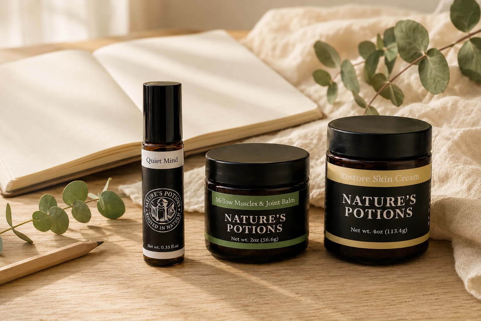 Nature’s Potions roller bottle on neutral linen beside eucalyptus leaves